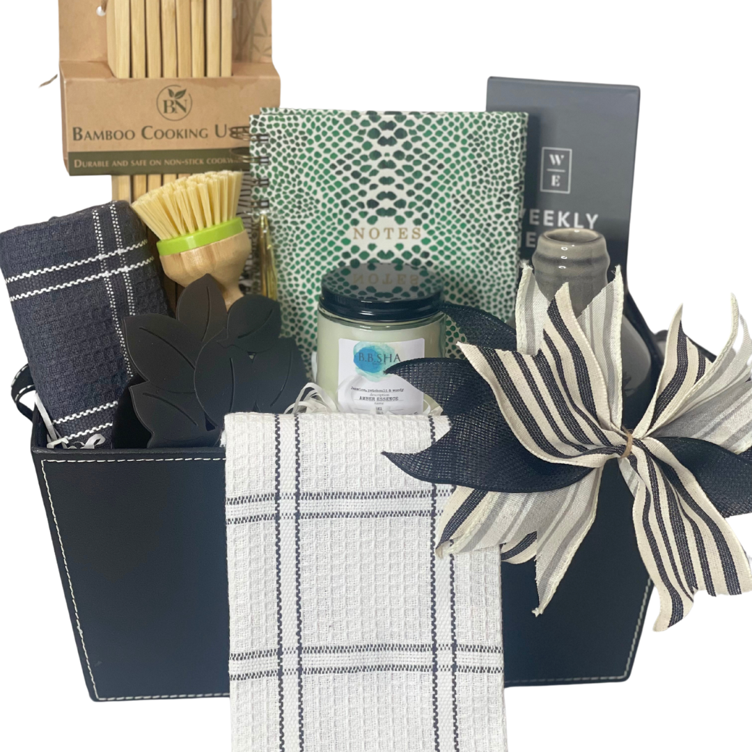 Charming Housewarming Gift Basket with stylish towels, a notebook, meal planning book, gray vase, gold pen, kitchen utensils, dish brush, sponge holder, and a hand-poured B.B.Sha candle. Perfect for welcoming new homeowners with comfort and style.